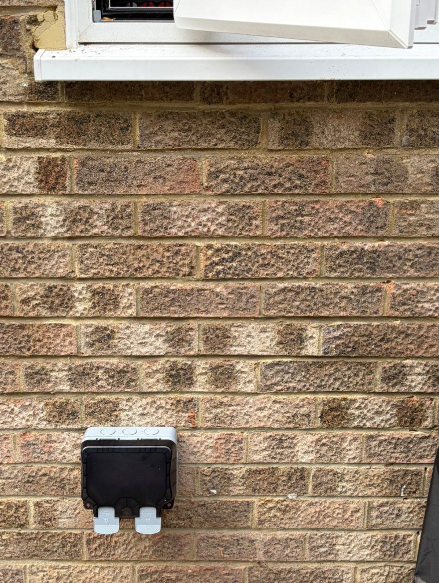 Weatherproof outside socket on a brick wall