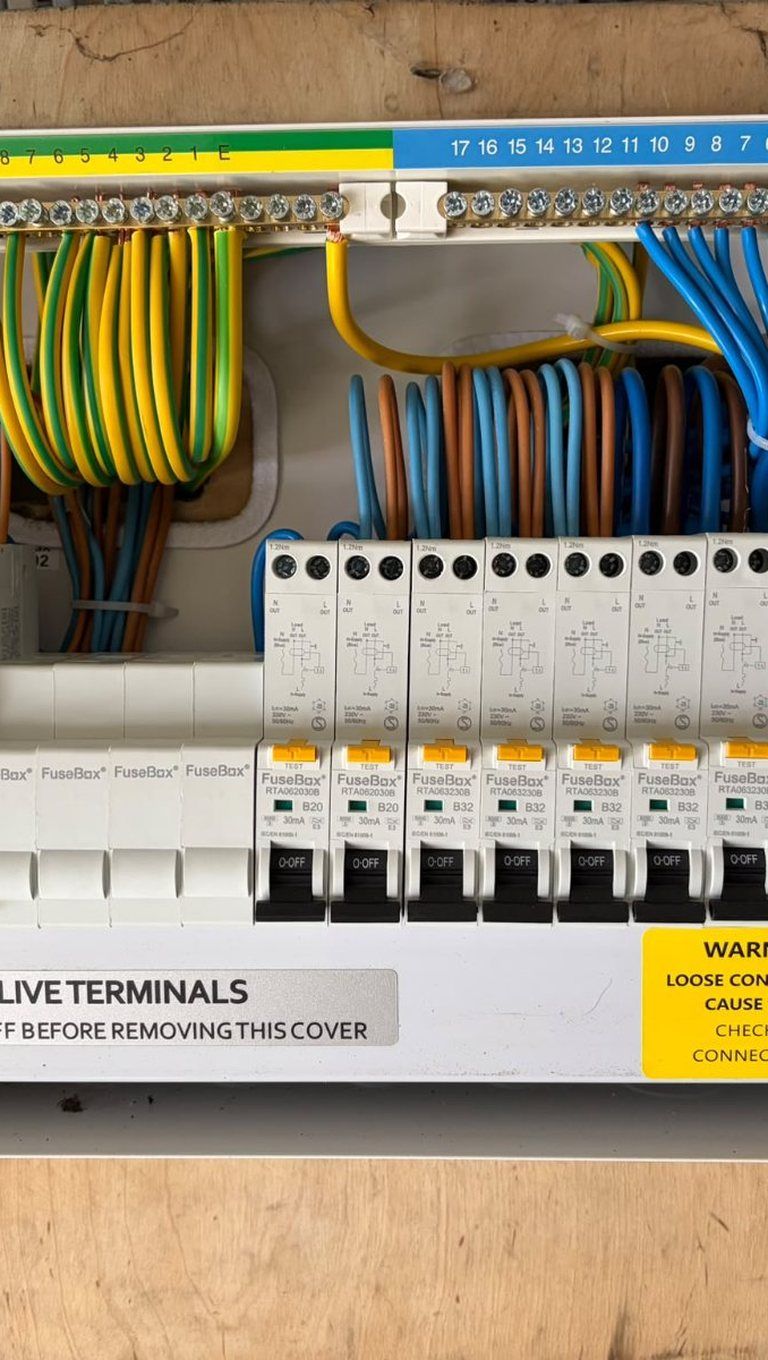 Inside a new consumer unit with the wiring dressed and labelled