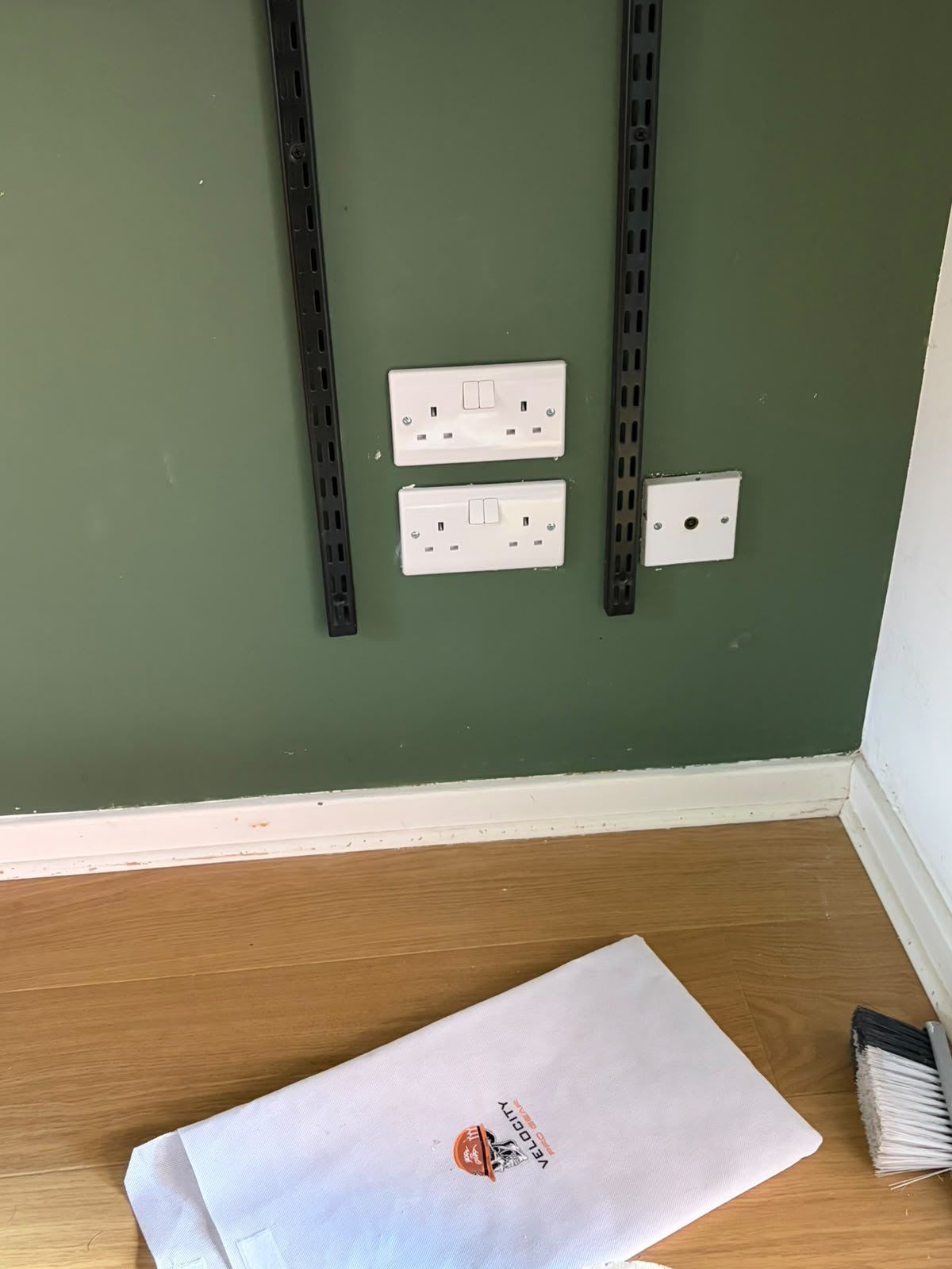 Two double sockets behind a TV stand after the work