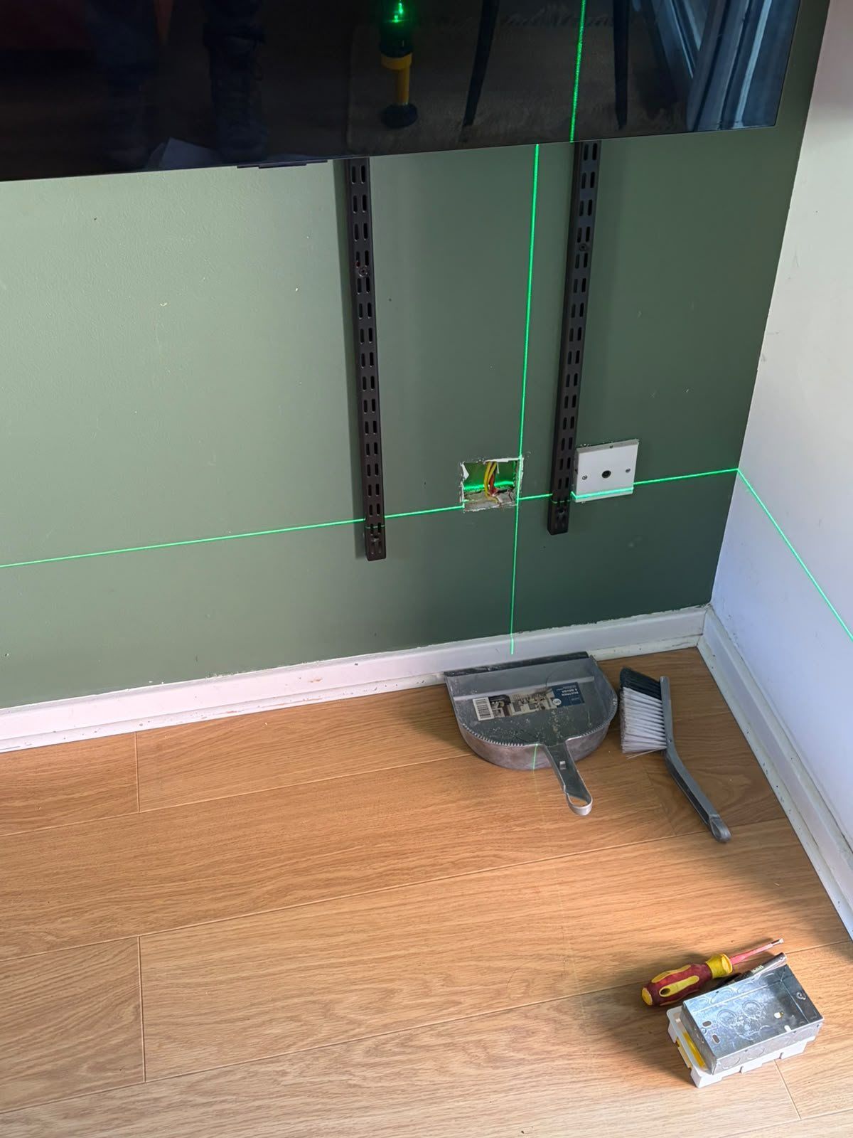 Single socket behind a TV stand before the work